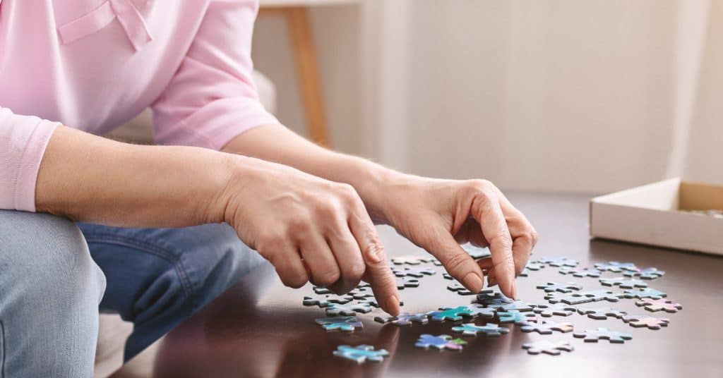Woman playing with jigsaw puzzle